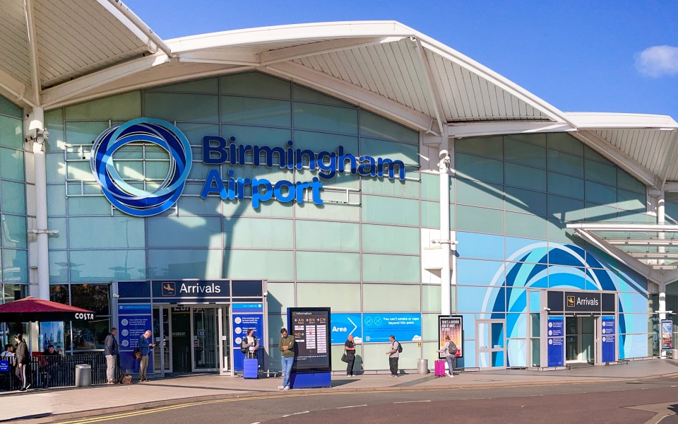 Birmingham Airport arrivals area with passengers.