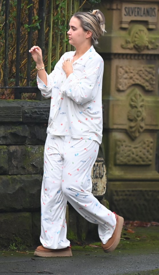 Woman in pajamas walking outside.