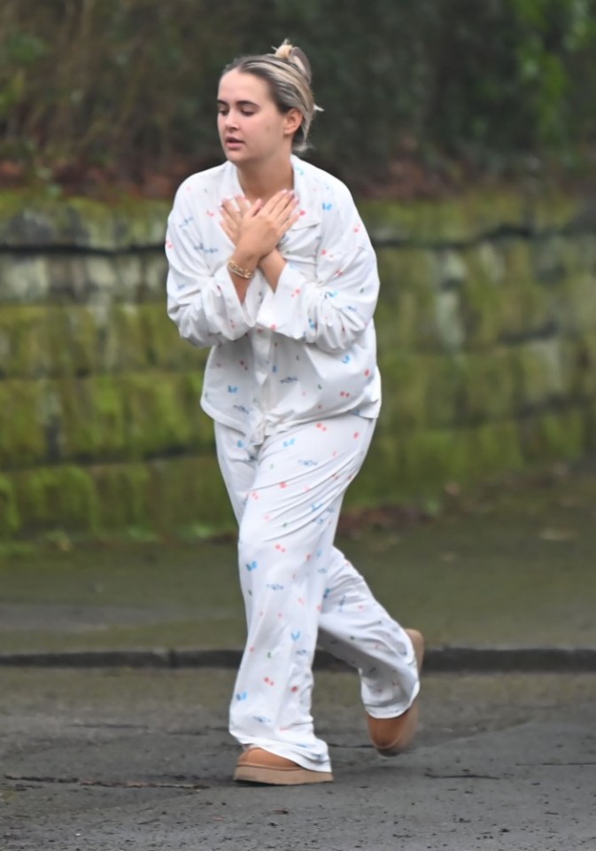 Woman in pajamas walking outdoors.