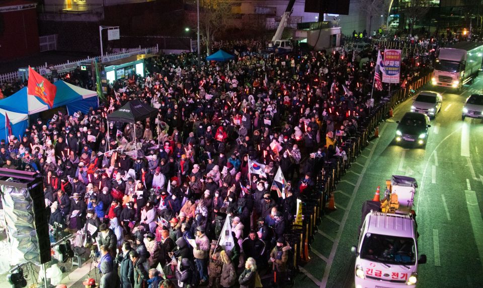 Large group of people rallying in support of impeached Korean President Yoon Suk-Yeol in Seoul.