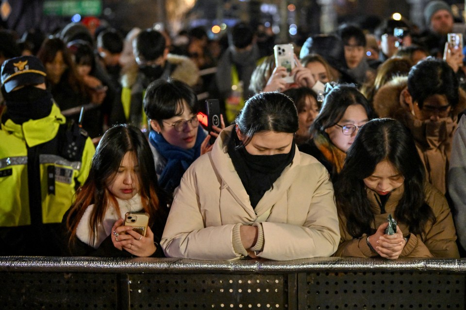 People pay tribute to the victims of the Jeju Air plane crash during a new year event in Seoul