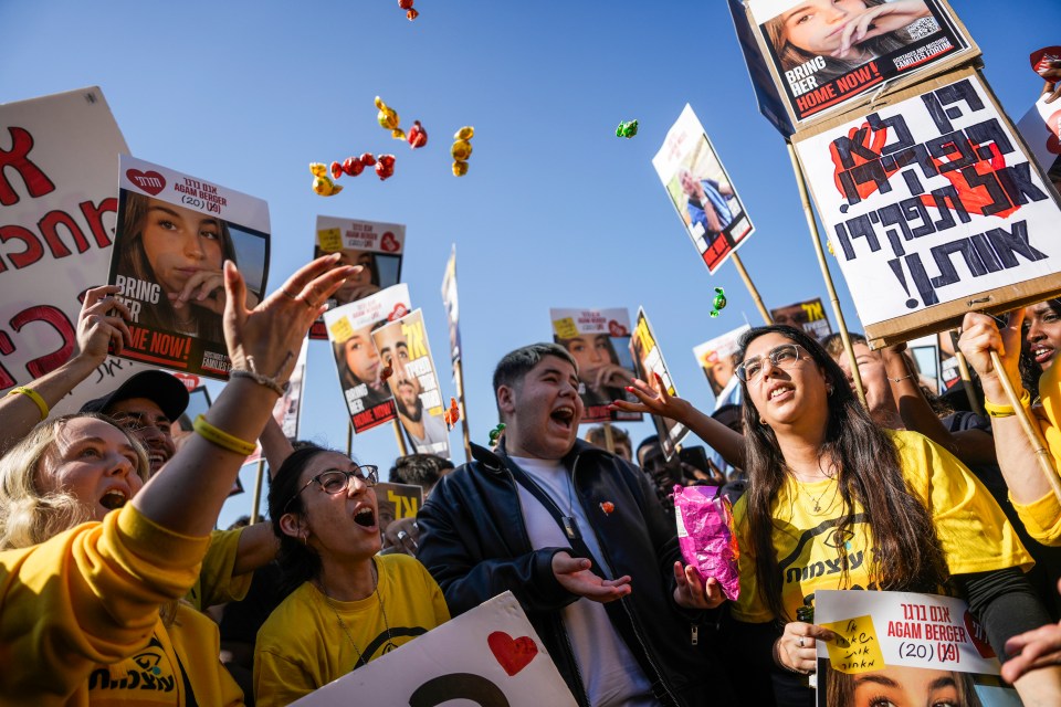 Protestors holding signs and photos demanding the release of Israeli hostages.