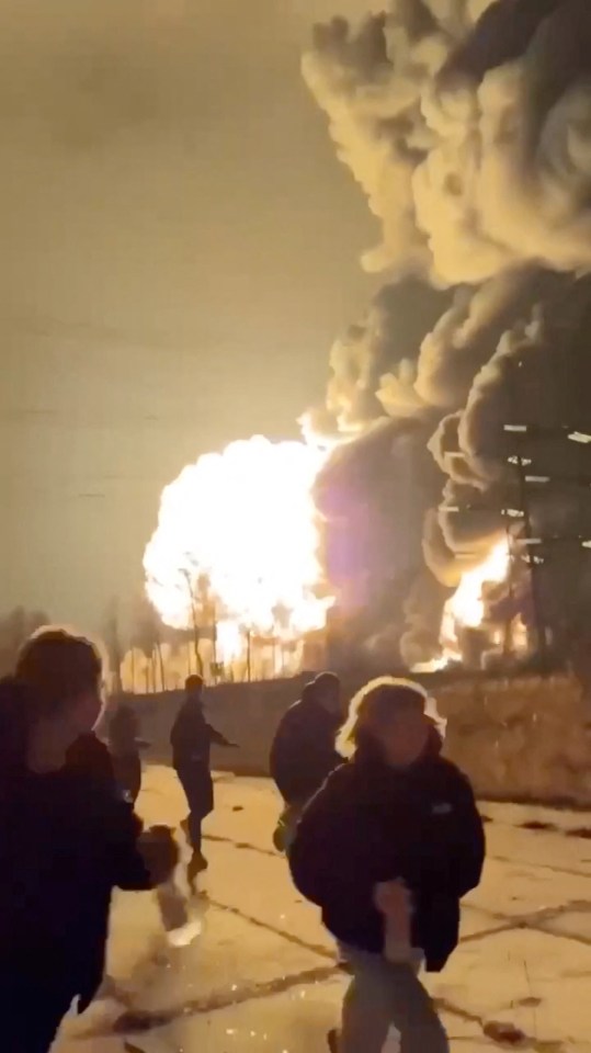 People running from a large explosion and fire.