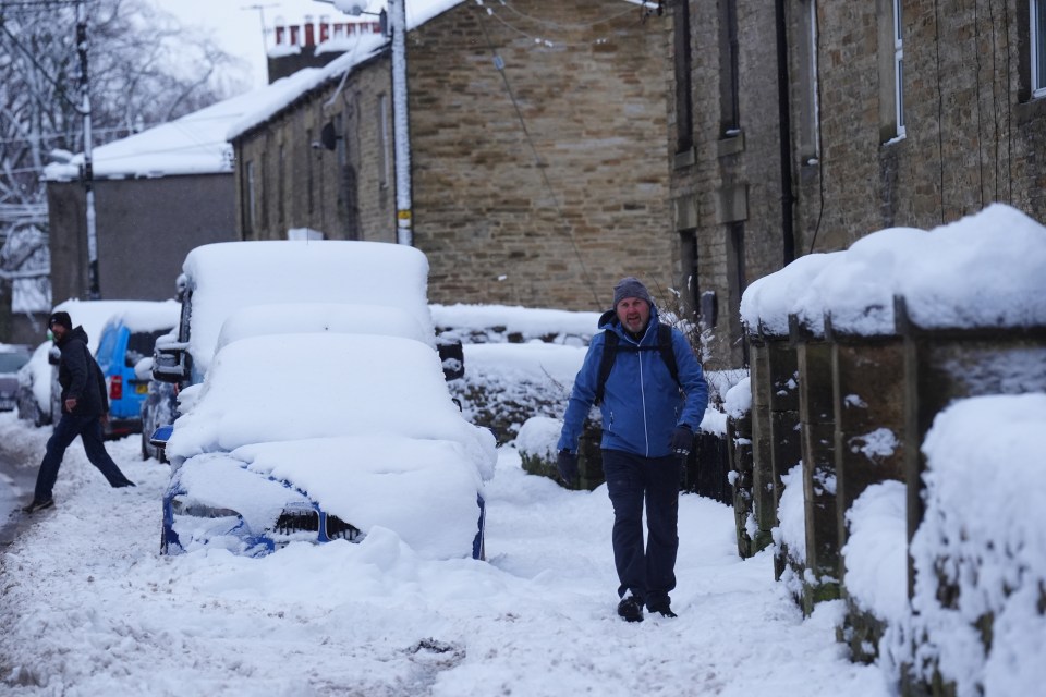 A person walks along a snow covered path in Allendale, Northumberland