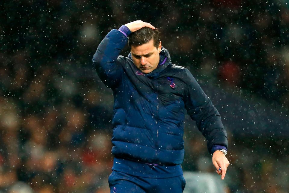 Mauricio Pochettino, Tottenham Hotspur's manager, looking distressed in the rain.