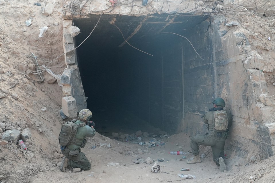 Israeli soldiers stand at the entrance of a tunnel in Rafah in the Gaza Strip