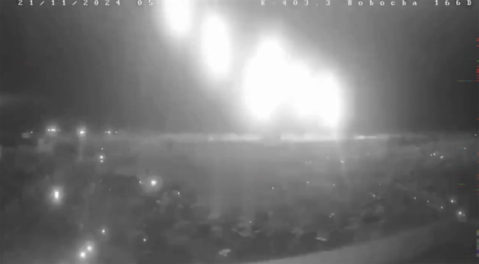 Nighttime security footage of explosions.