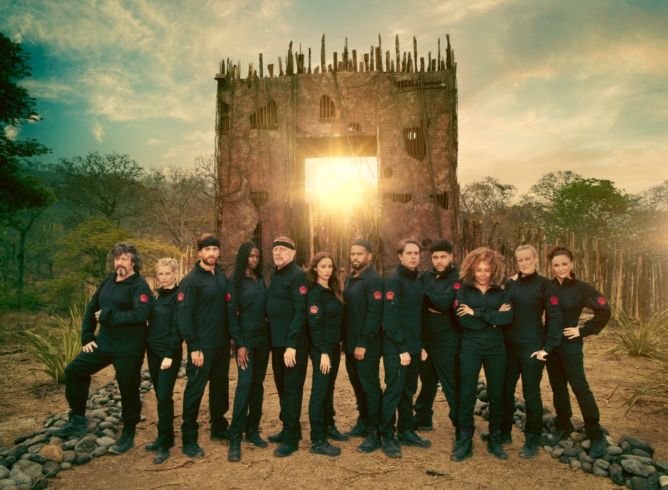 Group photo of Celebrity Bear Hunt contestants in front of a dilapidated structure.