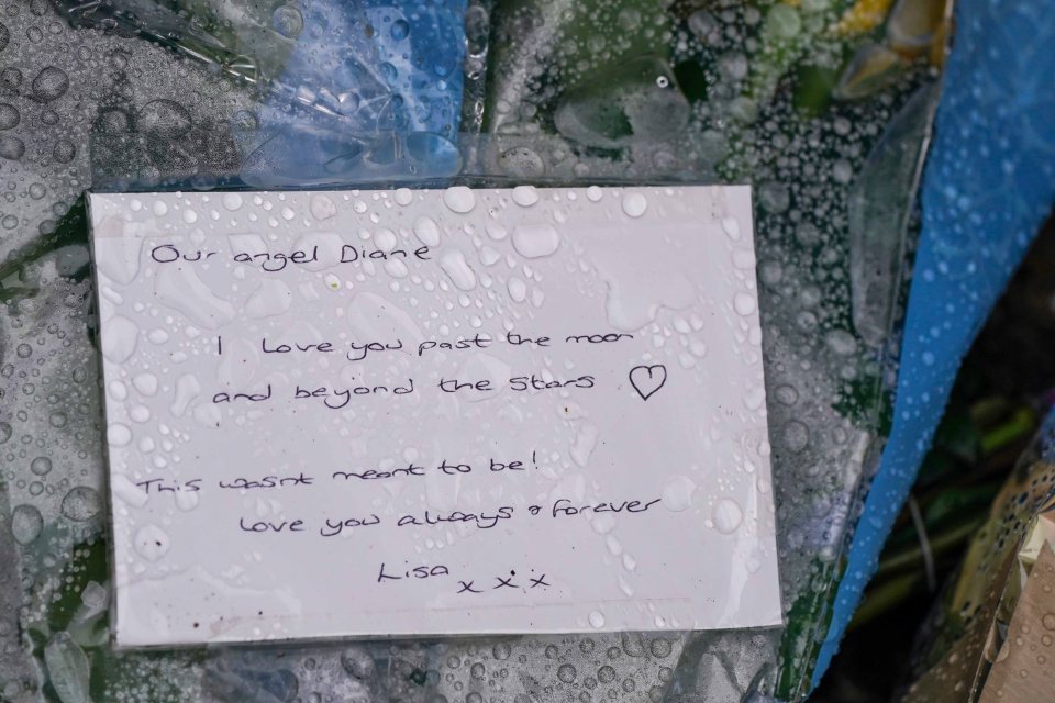 Handwritten tribute note left among flowers at a crime scene.