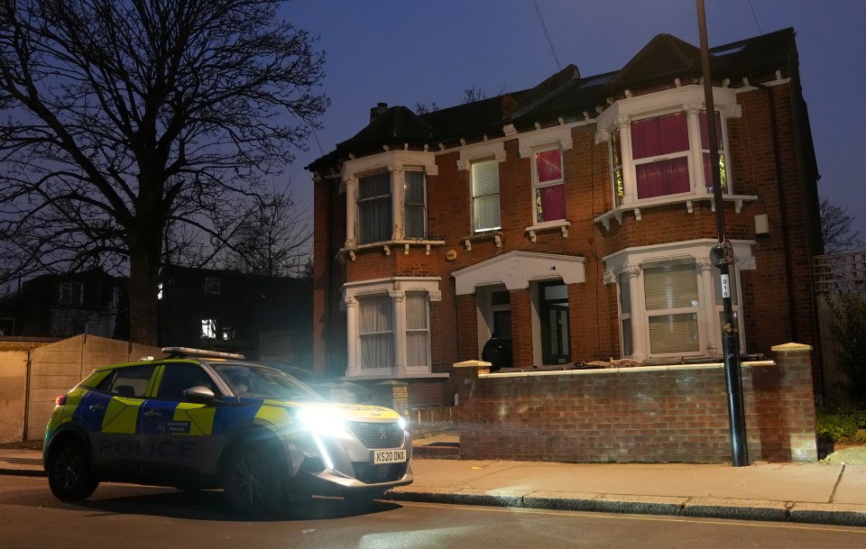 Police car parked outside a house at night; a murder investigation.