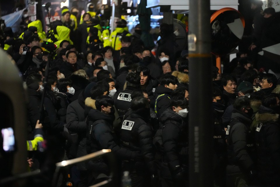 Police officers gathered near the residence of an impeached South Korean president.