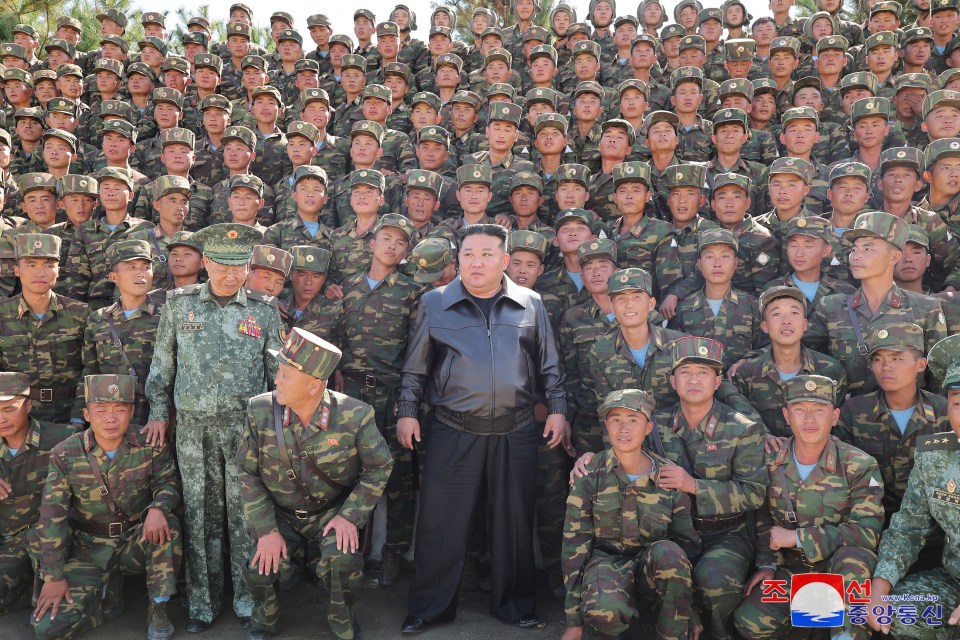 Kim Jong Un posing with North Korean troops.