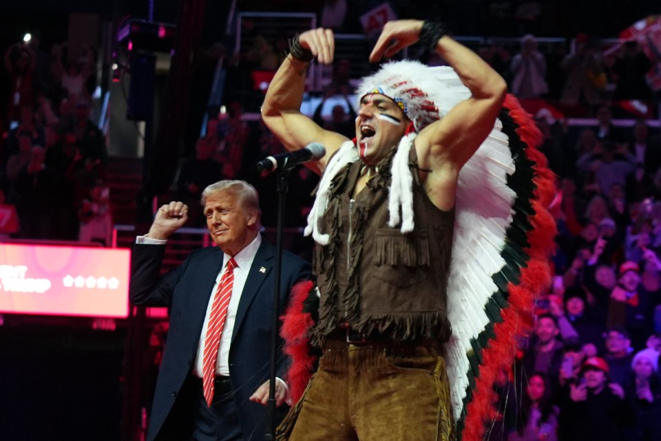 President-elect Donald Trump with a performer in Native American headdress.