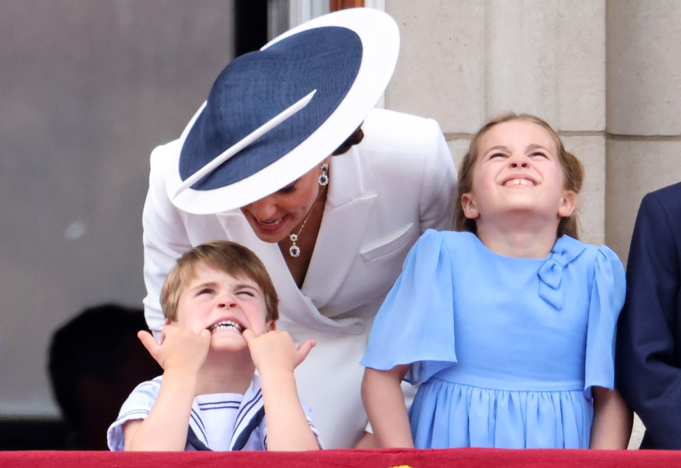 Prince Louis of Cambridge making a funny face with his sister Princess Charlotte and their mother Catherine, Duchess of Cambridge, at Buckingham Palace.