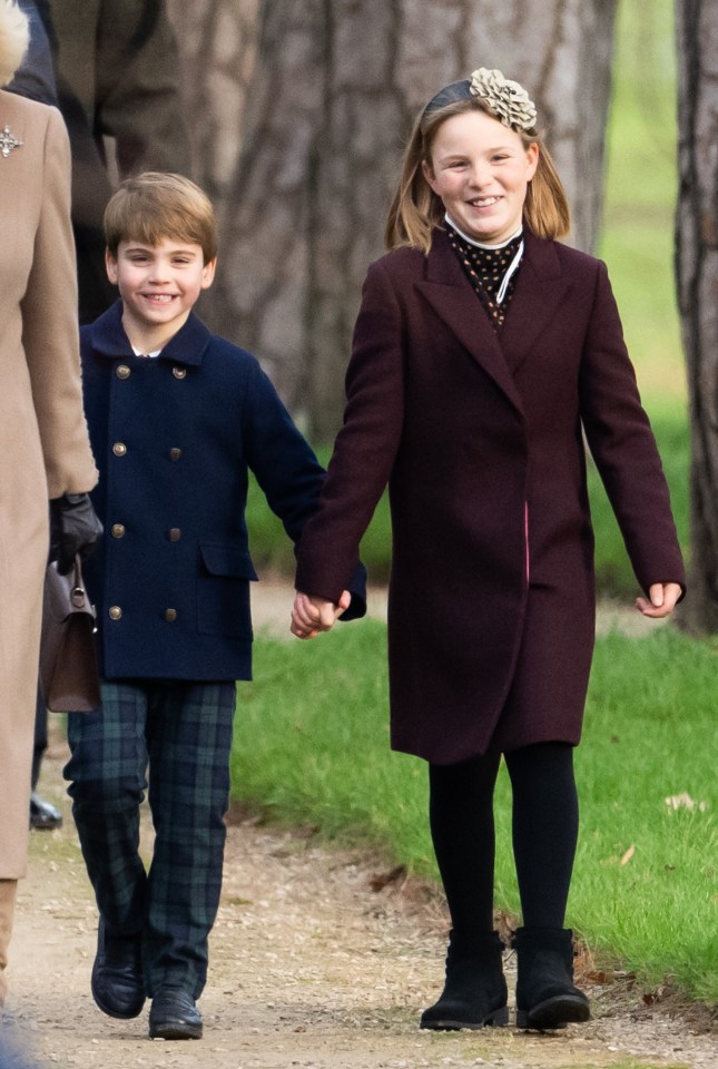 Prince Louis of Wales and Mia Tindall holding hands.