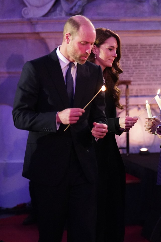 Prince William and Kate Middleton lighting candles at a Holocaust Memorial Day ceremony.