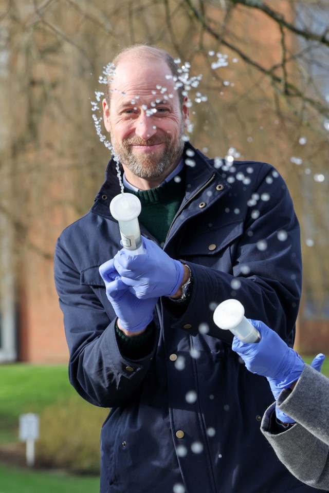 Prince William playfully filters water samples with school children.