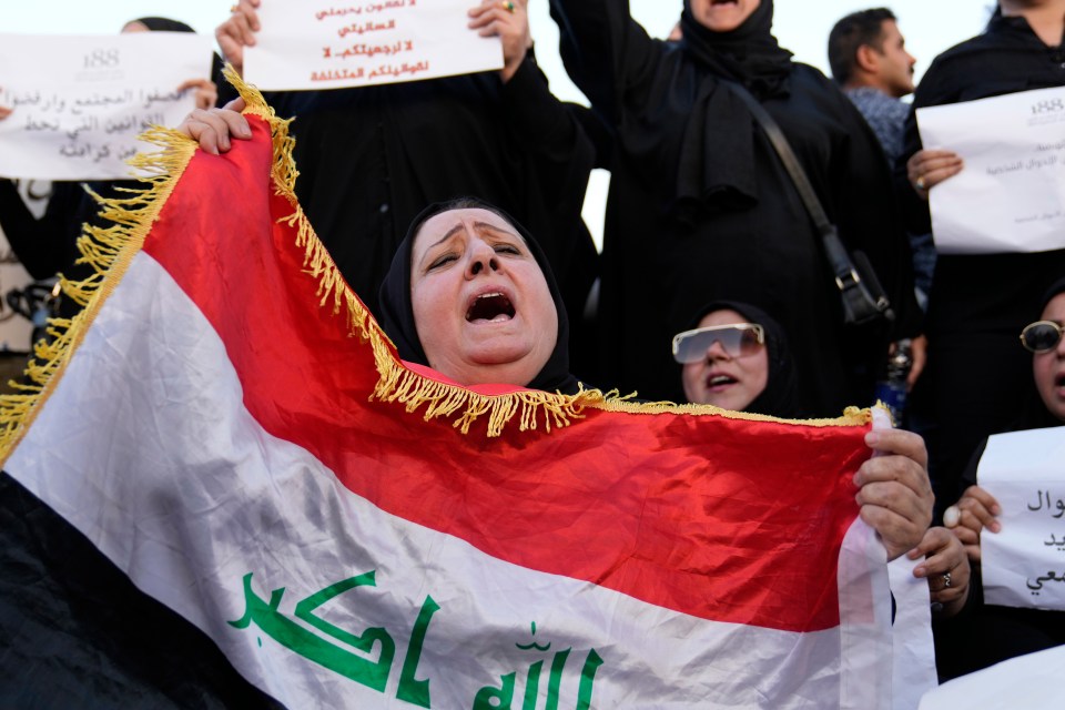 Iraqi woman protesting proposed law allowing underage marriage, holding Iraqi flag.