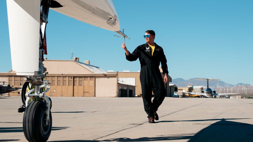 A test pilot inspecting a supersonic aircraft.