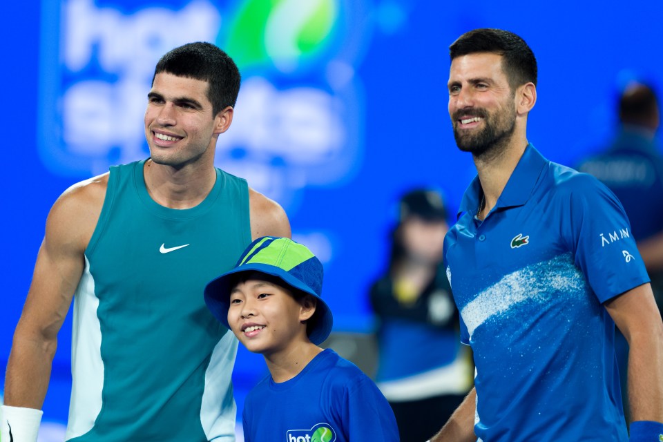 Novak Djokovic and Carlos Alcaraz with a child at the Australian Open.