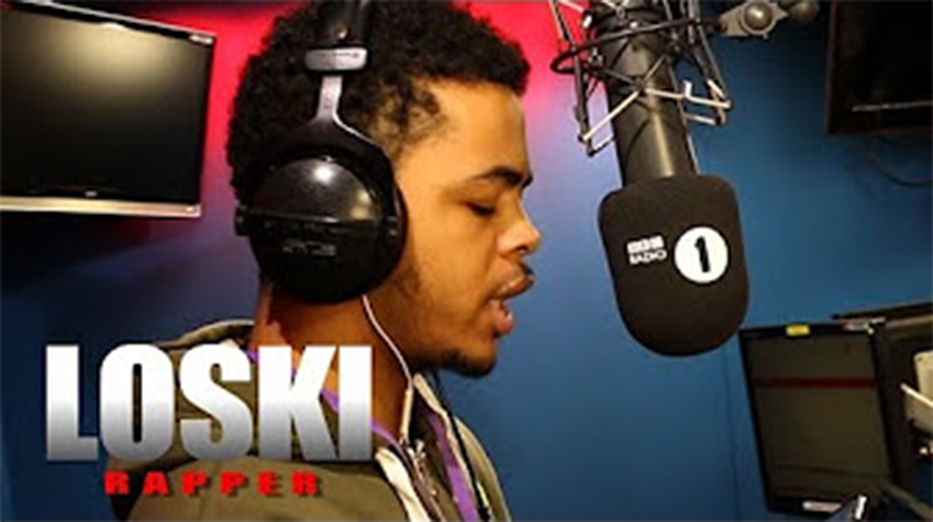 Rapper Loski recording in a studio.