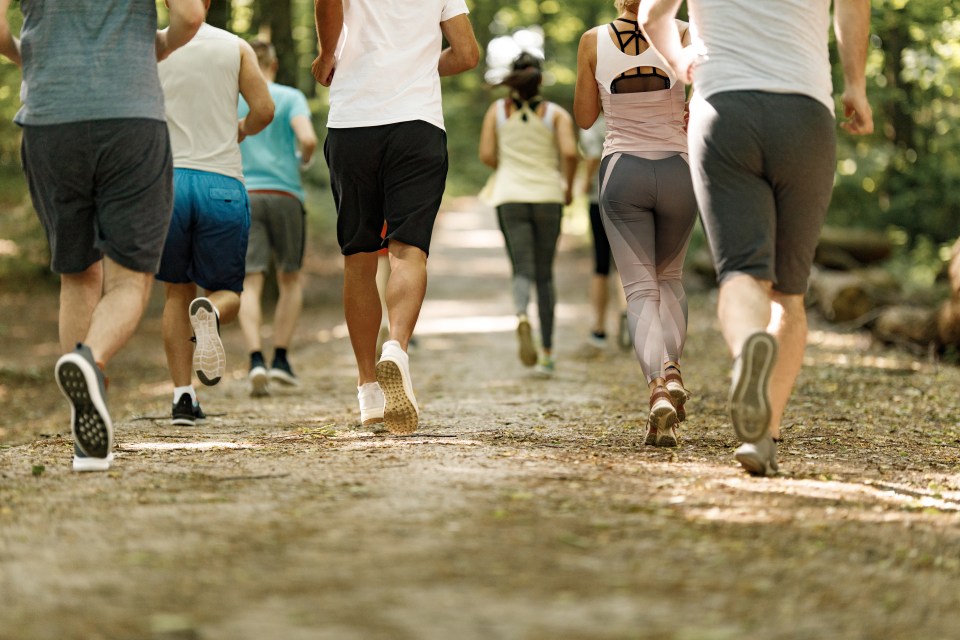 Rear view of a large group of people running a marathon.