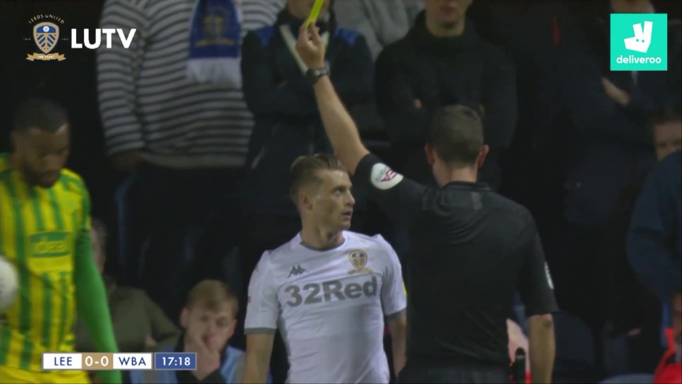 Referee showing a Leeds United player a yellow card.