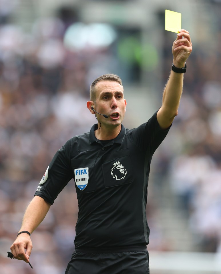 Soccer referee showing a yellow card.