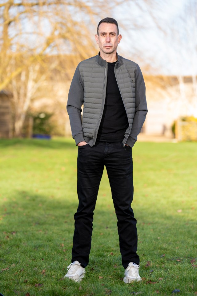 Referee David Coote standing outdoors.