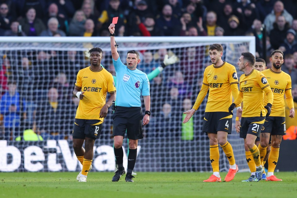 Referee showing a red card to a soccer player.