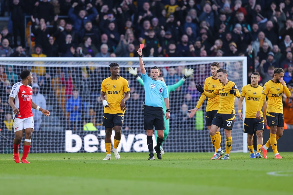 Referee showing a red card to a soccer player.