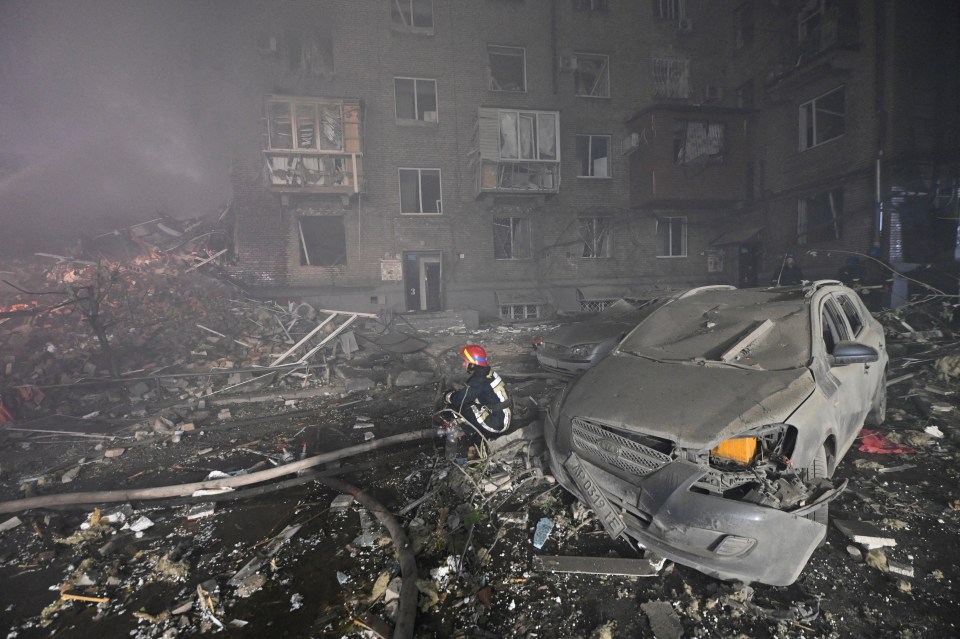 Rescuer at a damaged residential building after a missile strike.