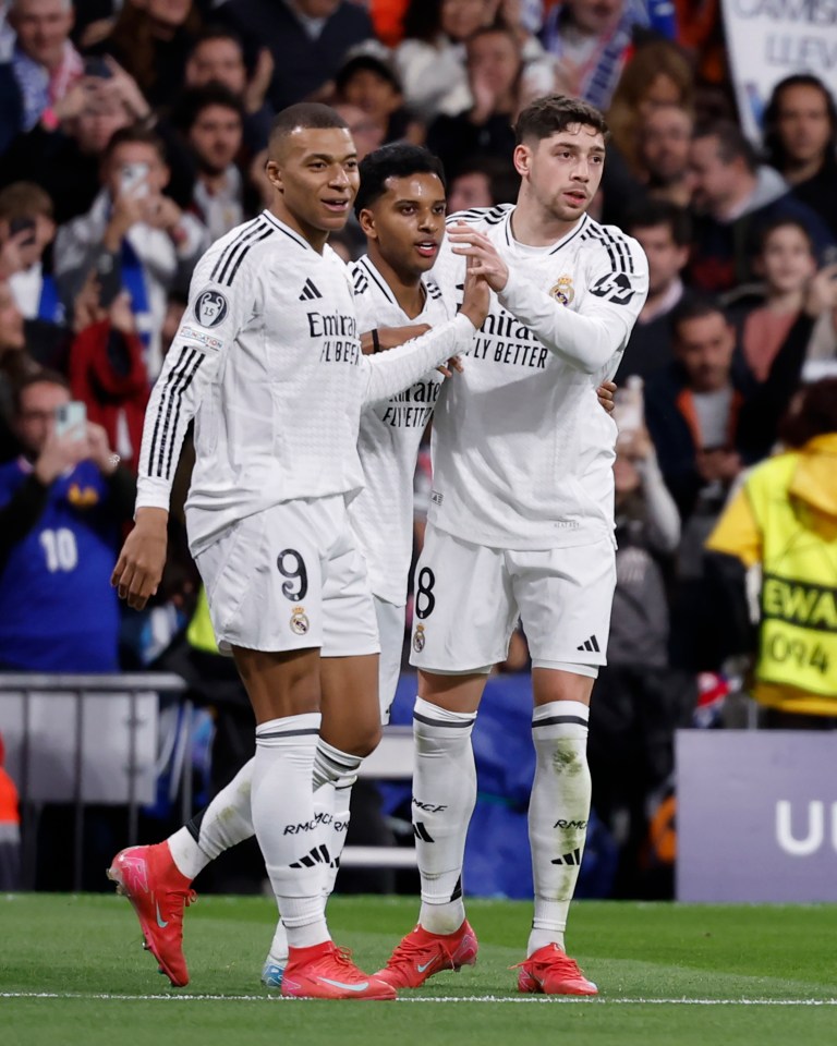 Real Madrid players celebrating a goal.