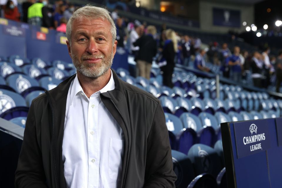 Roman Abramovich, Chelsea owner, smiling at a Champions League game.