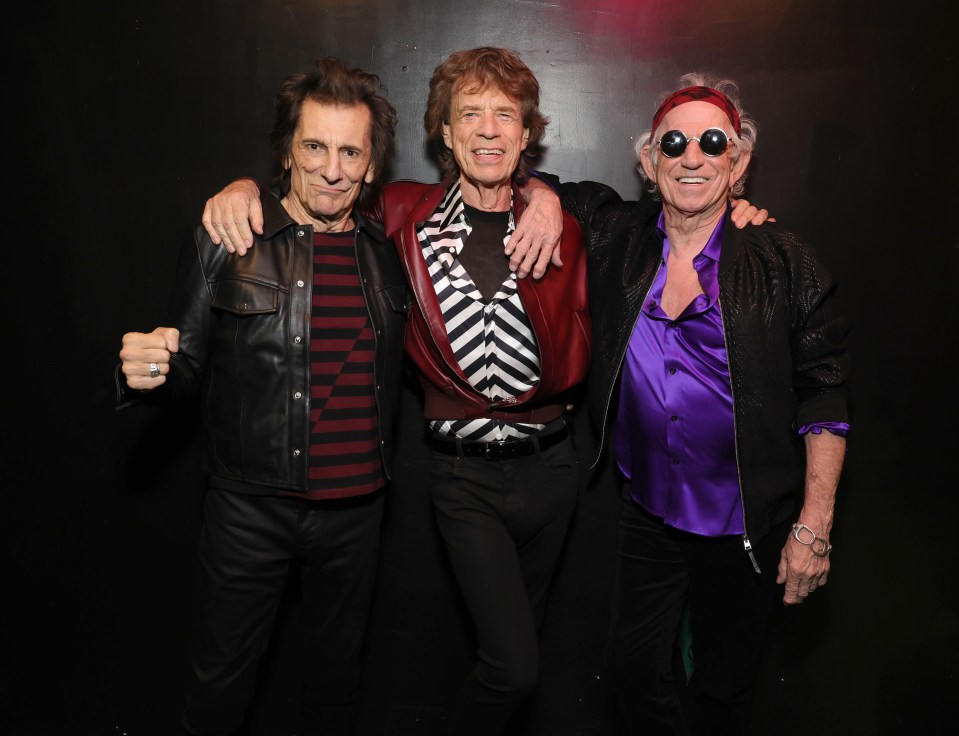 Ronnie Wood, Mick Jagger, and Keith Richards backstage.