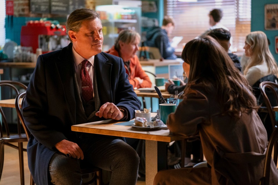 Mr. Barker and Ruby Allen having a conversation in a cafe.