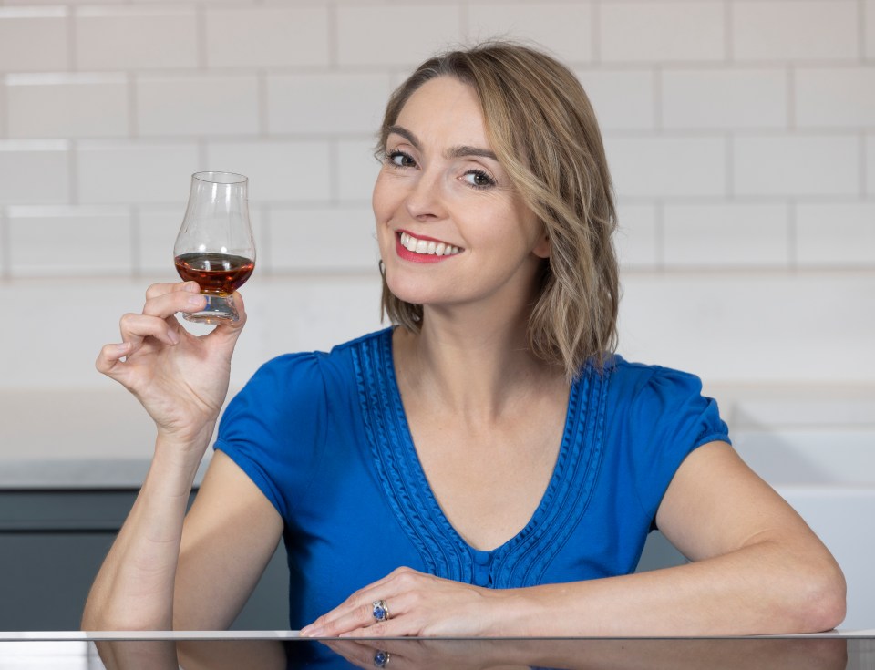 Woman holding a glass of rum.