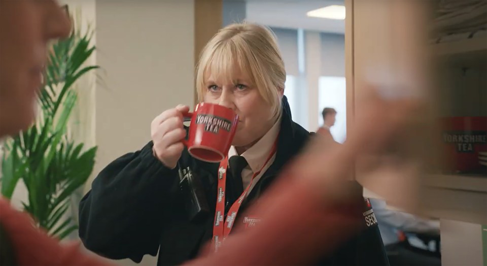 Sarah Lancashire drinking Yorkshire Tea from a mug in a parody of Happy Valley.