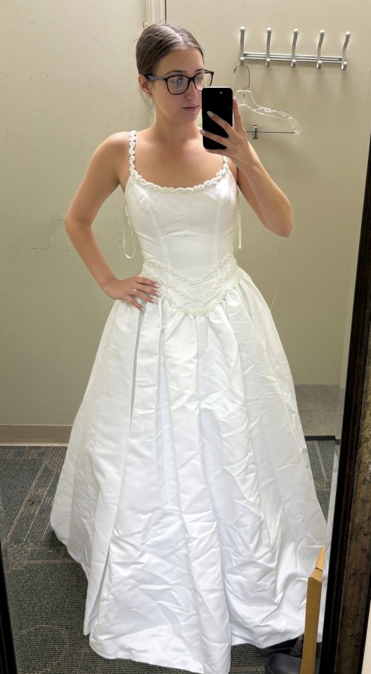 Woman in a $25 thrift store wedding dress.