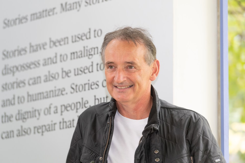 Pat Nevin, Scottish retired footballer and author, smiling at a photo call.