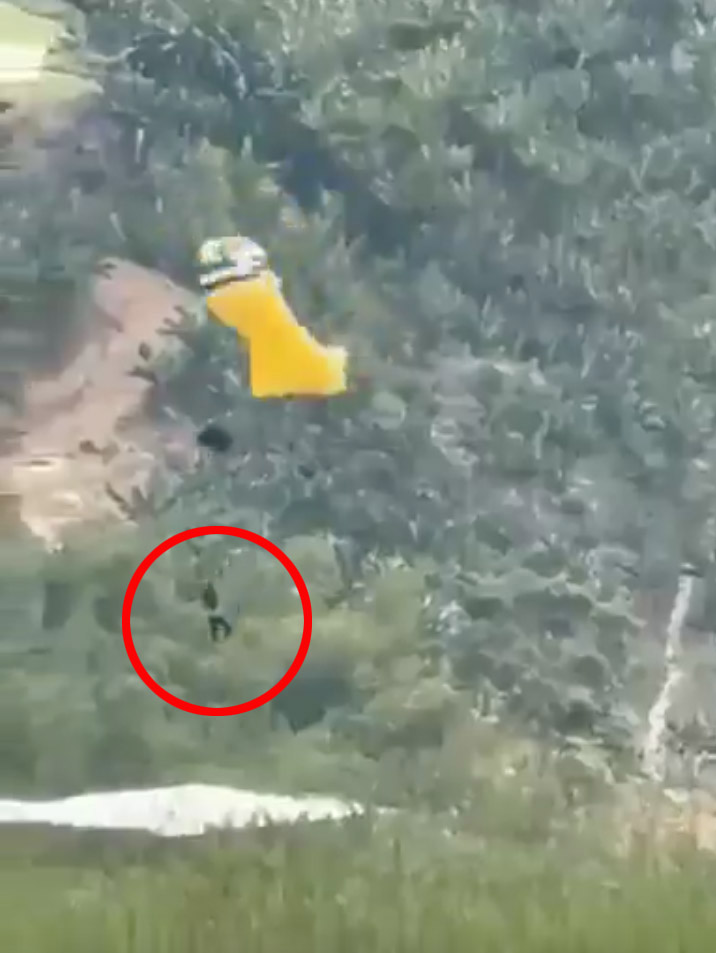 Video still of a skydiver falling to the ground.