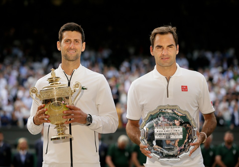 Novak Djokovic and Roger Federer holding their Wimbledon trophies.