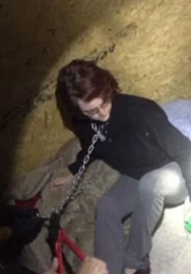 Woman chained inside a shipping container.