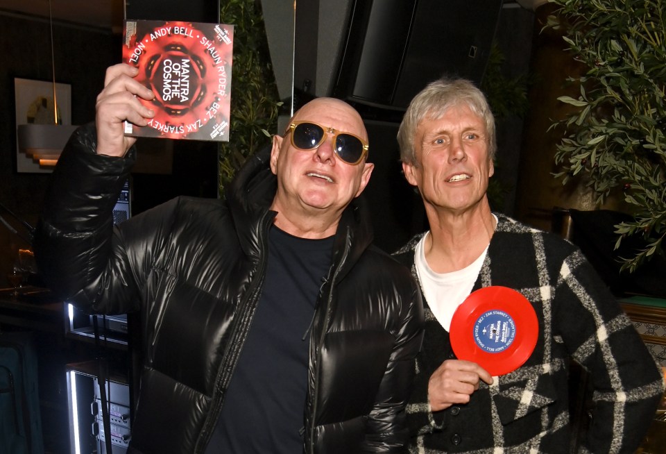 Shaun Ryder and Bez holding their Mantra of the Cosmos record.