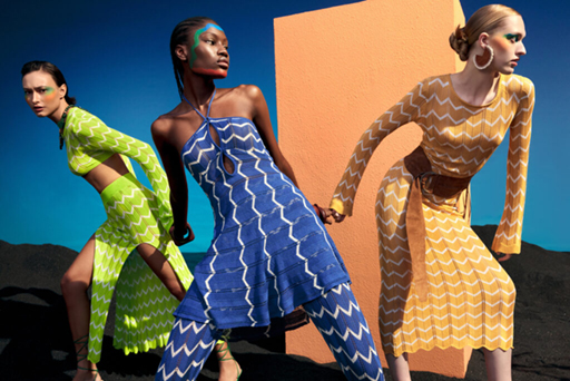 Three models wearing chevron-patterned knit dresses.