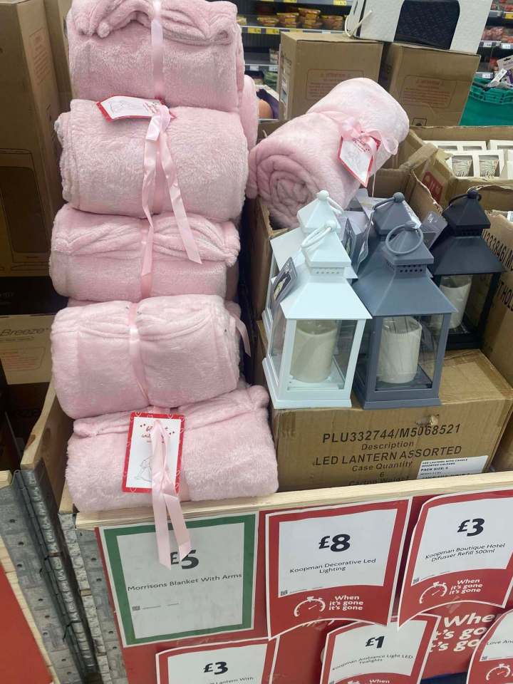 Pink blankets and LED lanterns for sale in a supermarket.