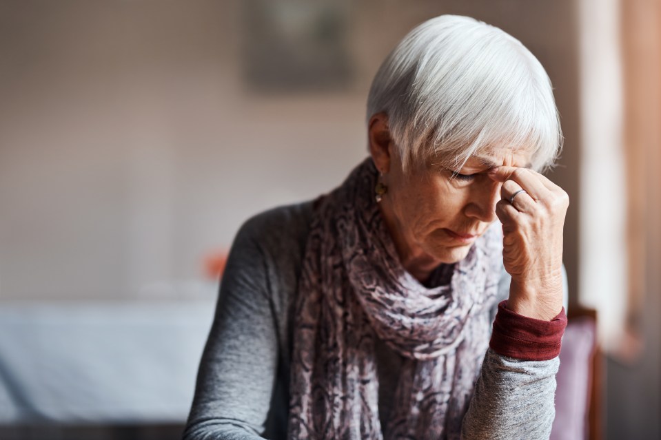 Senior woman with headache.