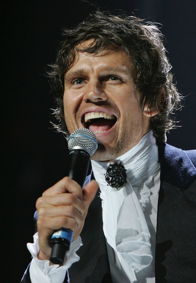 Jason Orange of Take That performing onstage.