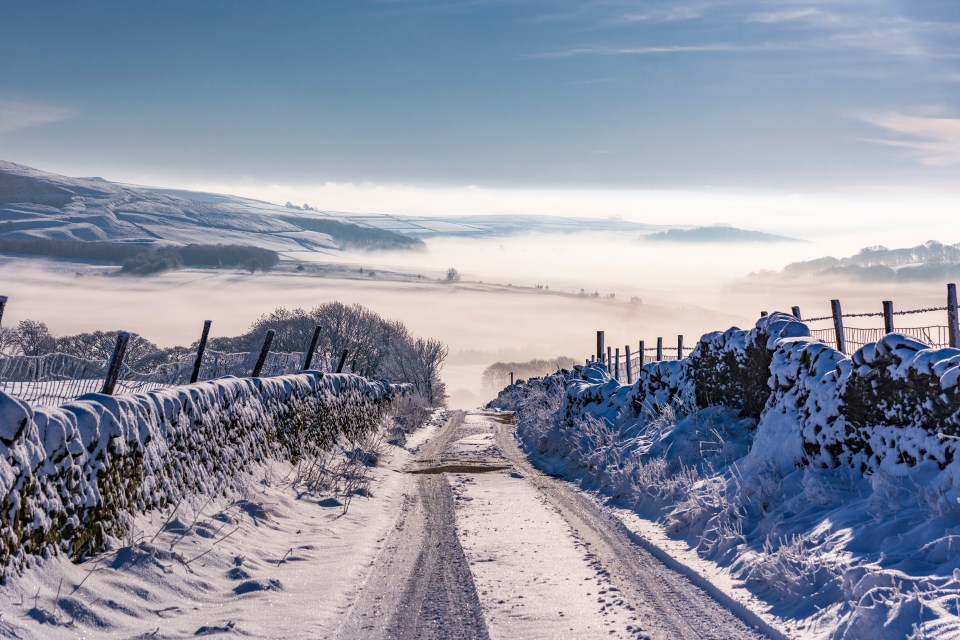 Snow-covered country lane in the Peak District National Park.