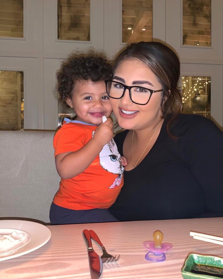 A mother and her young daughter sitting at a table.